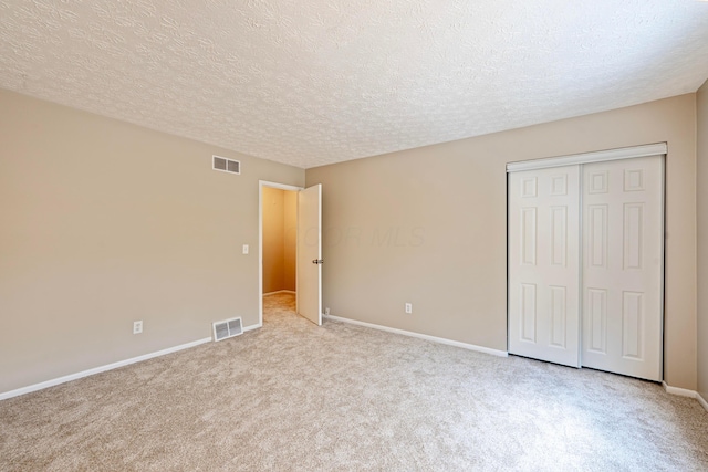 3033 Highcliff Ct, Columbus, OH 43231 - unfurnished bedroom with light colored carpet, a textured ceiling, and a closet