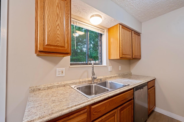 3033 Highcliff Ct, Columbus, OH 43231 - kitchen with stainless steel dishwasher, light countertops, a textured ceiling, and wood finished floors