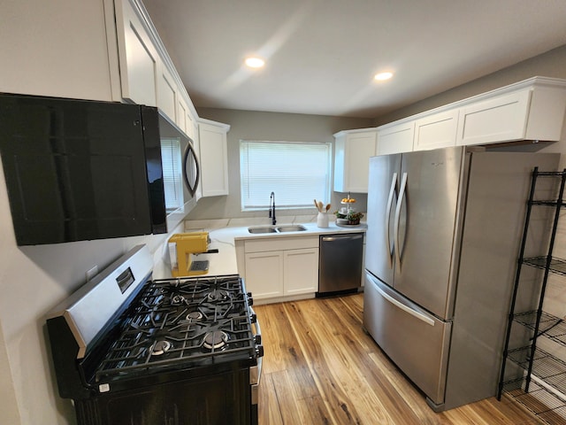 1826 Fleming Rd, Columbus, OH 43232 - kitchen with stainless steel appliances, white cabinetry, light wood-style floors, and recessed lighting