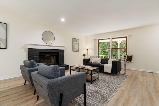 13900 Justin Rd, Utica, OH 43080 - living room featuring light wood-type flooring, a brick fireplace, and recessed lighting