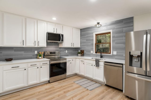 13900 Justin Rd, Utica, OH 43080 - kitchen with stainless steel appliances, backsplash, light countertops, and white cabinets