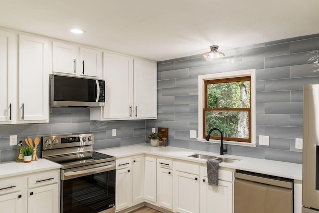 13900 Justin Rd, Utica, OH 43080 - kitchen with stainless steel appliances, light countertops, white cabinetry, and recessed lighting