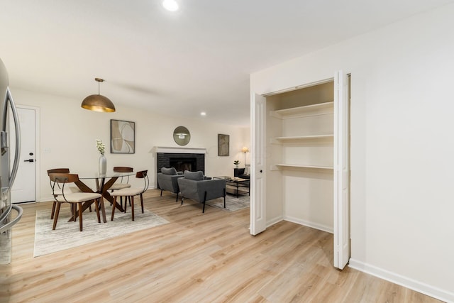 13900 Justin Rd, Utica, OH 43080 - dining space featuring light wood-style flooring, a fireplace, and recessed lighting