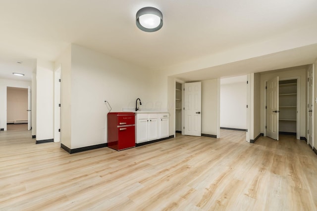 13900 Justin Rd, Utica, OH 43080 - unfurnished living room featuring light wood-type flooring and a baseboard heating unit