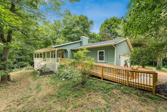 13900 Justin Rd, Utica, OH 43080 - rear view of property featuring a chimney, covered porch, and a garage