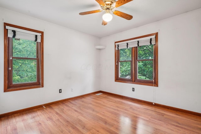 4867 Sarasota Ct, Hilliard, OH 43026 - empty room featuring plenty of natural light, light wood-type flooring, and a ceiling fan