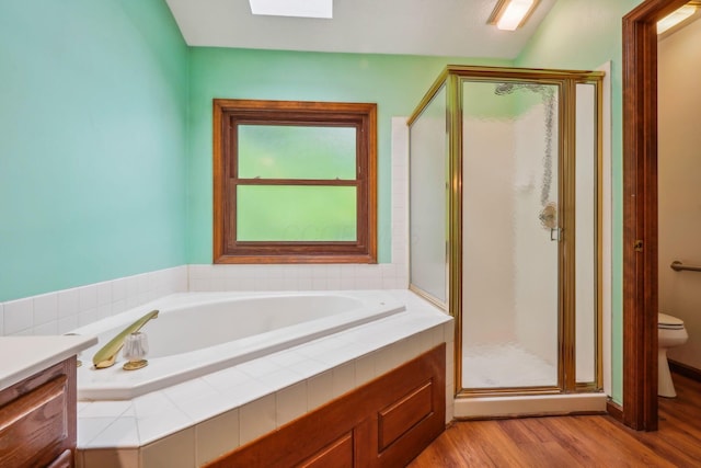4867 Sarasota Ct, Hilliard, OH 43026 - bathroom featuring a shower stall, a bath, wood finished floors, and vanity