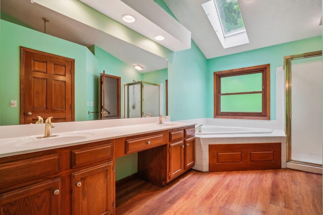 4867 Sarasota Ct, Hilliard, OH 43026 - full bathroom featuring a skylight, a stall shower, lofted ceiling, a garden tub, and double vanity