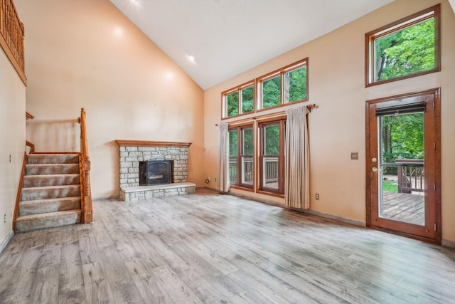 4867 Sarasota Ct, Hilliard, OH 43026 - unfurnished living room featuring high vaulted ceiling, wood finished floors, a fireplace, and stairway
