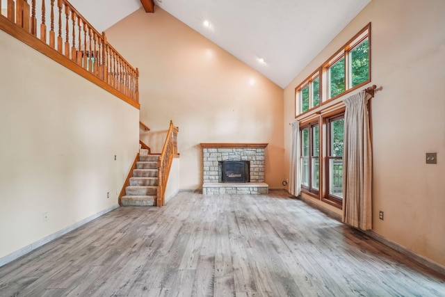 4867 Sarasota Ct, Hilliard, OH 43026 - unfurnished living room featuring high vaulted ceiling, wood finished floors, a fireplace, stairway, and beam ceiling