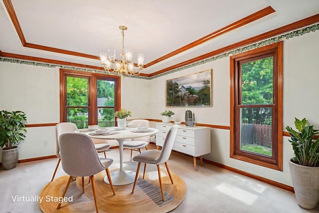 4867 Sarasota Ct, Hilliard, OH 43026 - dining space with a raised ceiling, a chandelier, crown molding, and light colored carpet