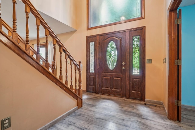 4867 Sarasota Ct, Hilliard, OH 43026 - foyer with wood finished floors, stairway, and a high ceiling