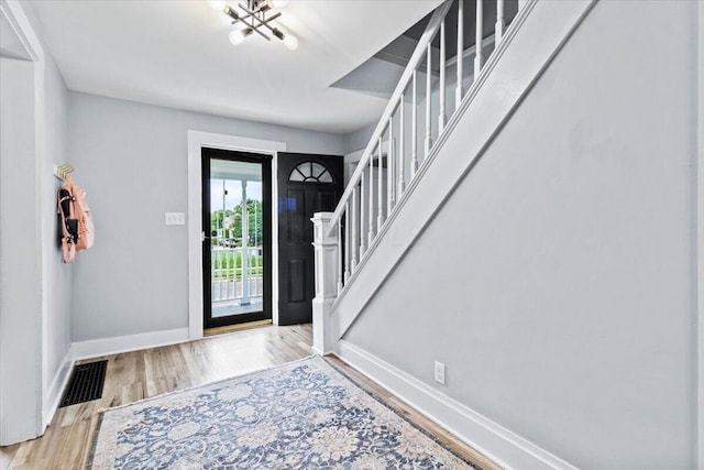 114 N 7th St, Newark, OH 43055 - entrance foyer with stairs, wood finished floors, and a chandelier