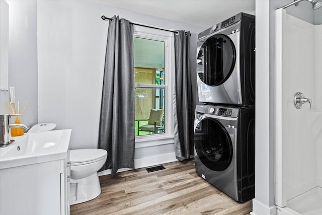 114 N 7th St, Newark, OH 43055 - laundry room featuring stacked washer / dryer and light wood finished floors
