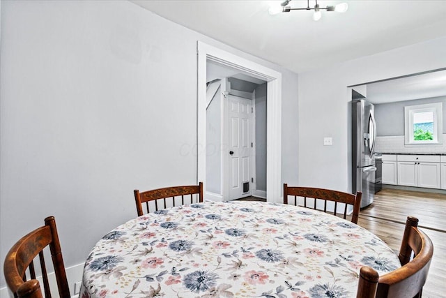 114 N 7th St, Newark, OH 43055 - dining area with light wood-type flooring and baseboards