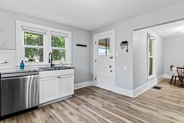 114 N 7th St, Newark, OH 43055 - kitchen with stainless steel dishwasher, healthy amount of natural light, light wood-style flooring, and light stone counters