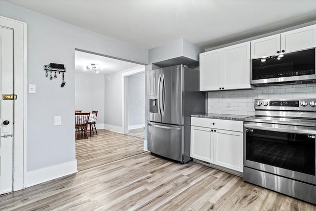 114 N 7th St, Newark, OH 43055 - kitchen with stainless steel appliances, light wood-style floors, backsplash, and white cabinets