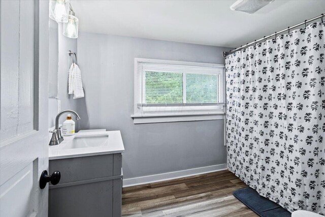 114 N 7th St, Newark, OH 43055 - full bath with wood finished floors, vanity, and curtained shower