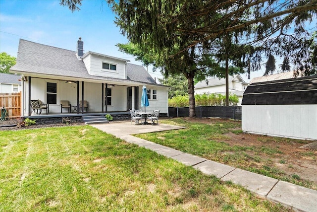 114 N 7th St, Newark, OH 43055 - rear view of property with a shed, a fenced backyard, a chimney, and a ceiling fan