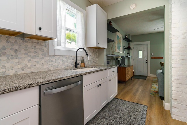 2686 Wicklow Rd, Columbus, OH 43204 - kitchen featuring dishwasher, light wood-style flooring, backsplash, and white cabinetry