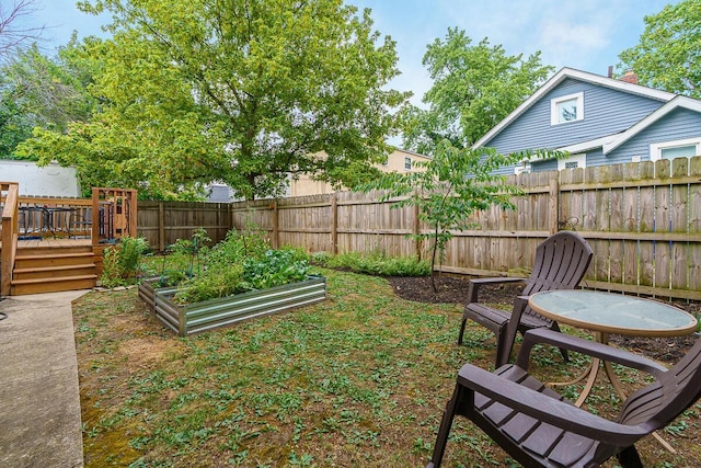 2686 Wicklow Rd, Columbus, OH 43204 - fenced backyard featuring a vegetable garden and a deck