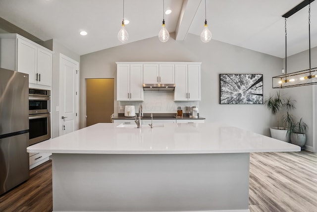 25500 Storms Rd, West Mansfield, OH 43358 - kitchen with appliances with stainless steel finishes, dark wood finished floors, decorative backsplash, under cabinet range hood, and white cabinets