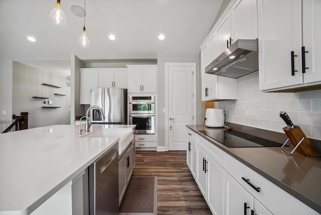 25500 Storms Rd, West Mansfield, OH 43358 - kitchen featuring wall chimney exhaust hood, appliances with stainless steel finishes, tasteful backsplash, white cabinets, and hanging light fixtures