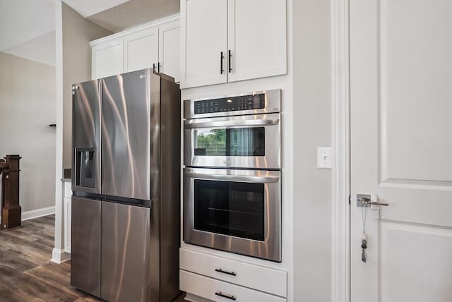 25500 Storms Rd, West Mansfield, OH 43358 - kitchen with appliances with stainless steel finishes, white cabinetry, and dark wood-style flooring