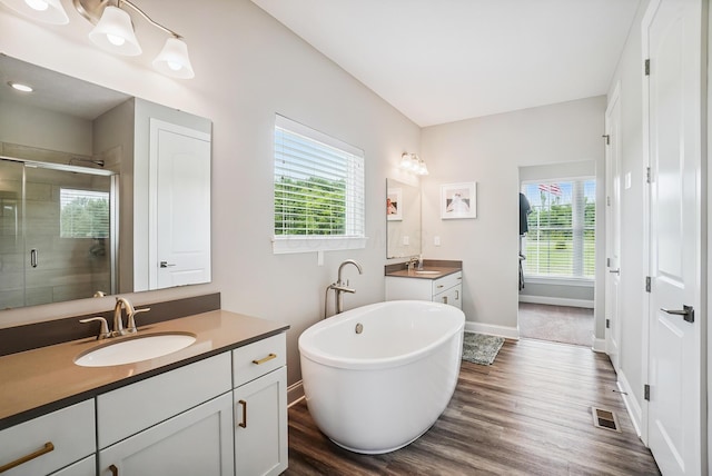 25500 Storms Rd, West Mansfield, OH 43358 - full bath featuring two vanities, a stall shower, plenty of natural light, and a soaking tub
