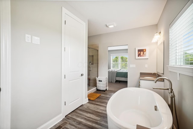 25500 Storms Rd, West Mansfield, OH 43358 - full bath featuring a stall shower, a soaking tub, double vanity, wood finished floors, and connected bathroom