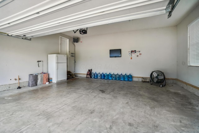25500 Storms Rd, West Mansfield, OH 43358 - garage featuring freestanding refrigerator and a garage door opener