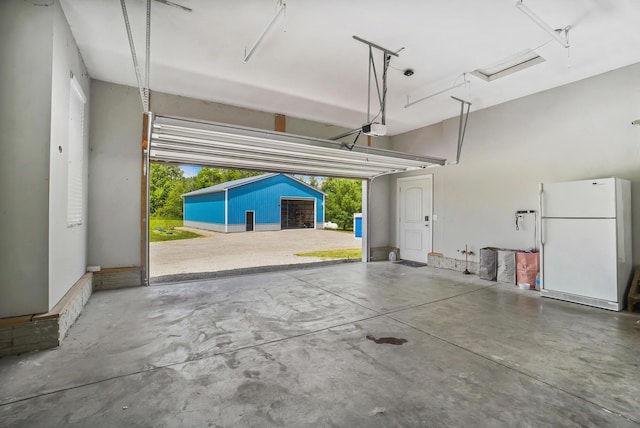 25500 Storms Rd, West Mansfield, OH 43358 - garage with freestanding refrigerator and a garage door opener