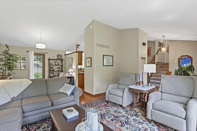 680 Rainbow Dr NW, Lancaster, OH 43130 - living area featuring light wood-type flooring, stairway, and vaulted ceiling