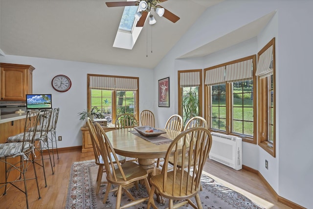 680 Rainbow Dr NW, Lancaster, OH 43130 - dining room featuring ceiling fan, lofted ceiling, light wood-style flooring, and a skylight