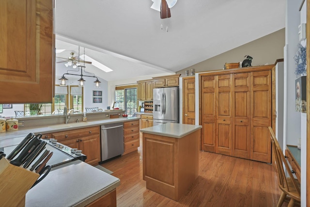 680 Rainbow Dr NW, Lancaster, OH 43130 - kitchen with stainless steel appliances, ceiling fan, vaulted ceiling, a skylight, and light countertops