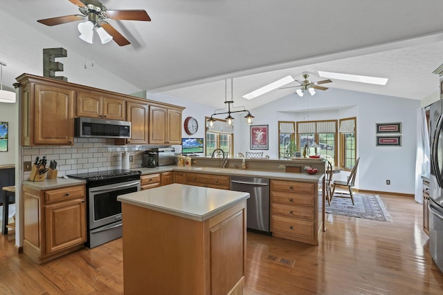 680 Rainbow Dr NW, Lancaster, OH 43130 - kitchen with stainless steel appliances, lofted ceiling, a skylight, ceiling fan, and a peninsula