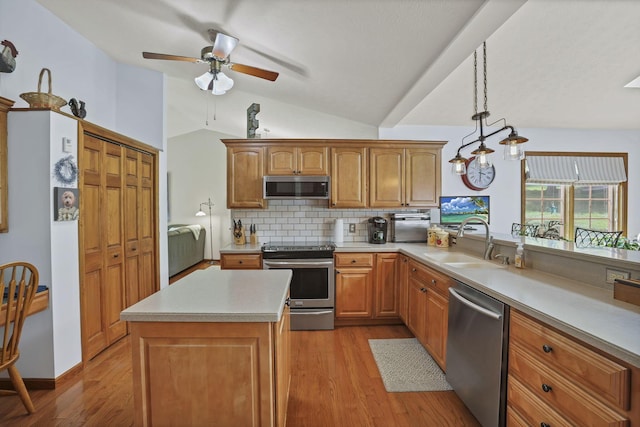680 Rainbow Dr NW, Lancaster, OH 43130 - kitchen with appliances with stainless steel finishes, light wood-style floors, lofted ceiling, ceiling fan, and decorative backsplash