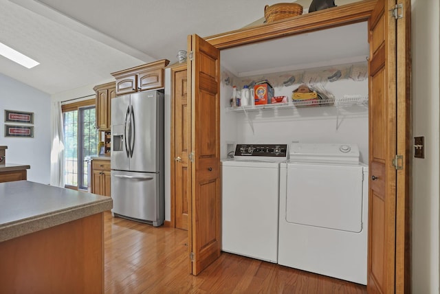 680 Rainbow Dr NW, Lancaster, OH 43130 - laundry room with independent washer and dryer, light wood-style floors, and a skylight