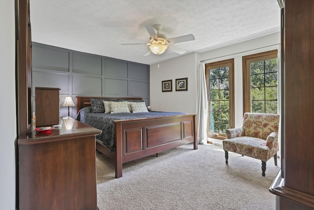 680 Rainbow Dr NW, Lancaster, OH 43130 - carpeted bedroom featuring a decorative wall, a textured ceiling, and ceiling fan