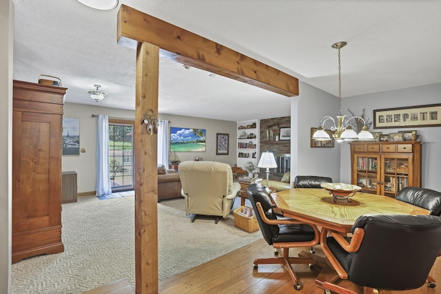 680 Rainbow Dr NW, Lancaster, OH 43130 - dining area with a chandelier, a textured ceiling, light wood-style floors, and built in features
