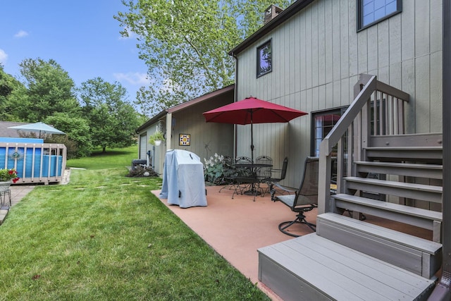 680 Rainbow Dr NW, Lancaster, OH 43130 - view of green lawn with a patio area and outdoor dining space