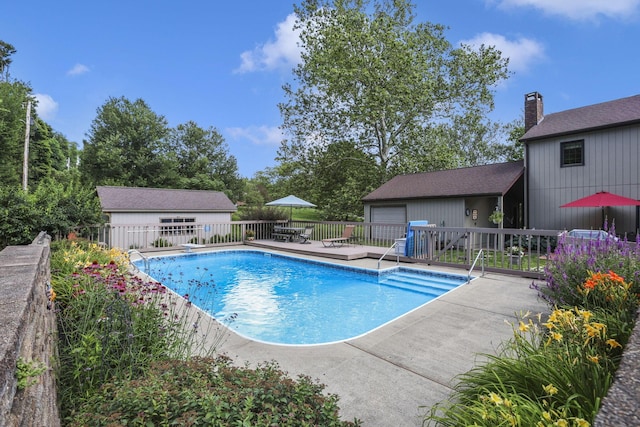 680 Rainbow Dr NW, Lancaster, OH 43130 - view of swimming pool with an outdoor structure, a patio area, and a wooden deck