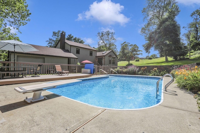 680 Rainbow Dr NW, Lancaster, OH 43130 - swimming pool with a diving board, a wooden deck, and a patio