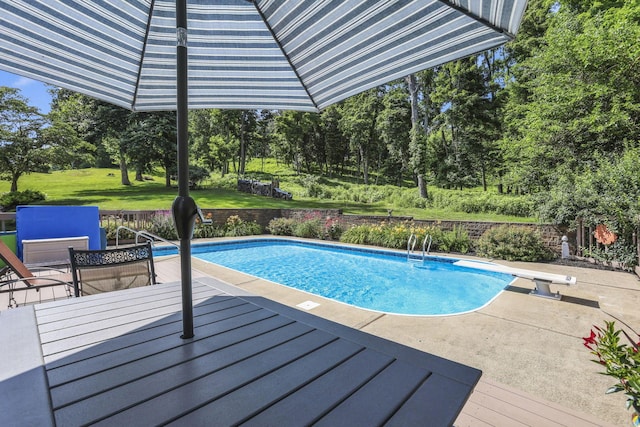 680 Rainbow Dr NW, Lancaster, OH 43130 - outdoor pool featuring a diving board, view of scattered trees, a patio area, and a wooden deck