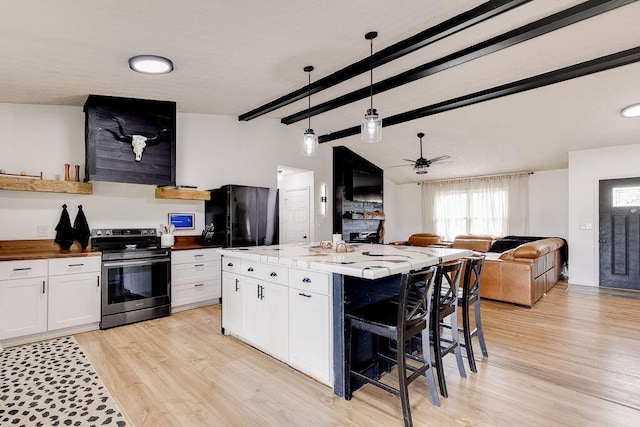 9710 Butcher Rd, Mount Vernon, OH 43050 - kitchen with stainless steel electric range, fridge, white cabinetry, and light wood-style flooring