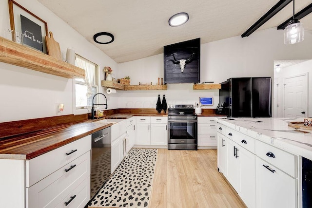 9710 Butcher Rd, Mount Vernon, OH 43050 - kitchen with stainless steel appliances, wood counters, open shelves, white cabinetry, and light wood-style flooring