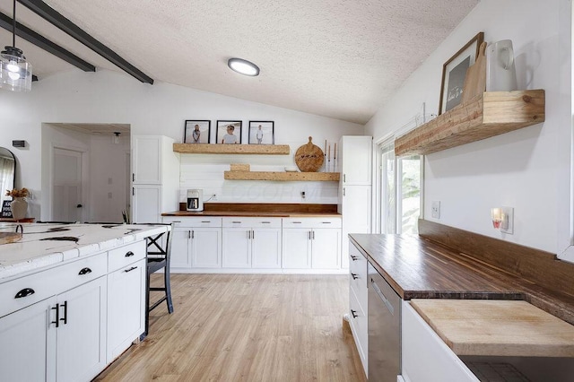 9710 Butcher Rd, Mount Vernon, OH 43050 - kitchen with open shelves, light wood-style floors, white cabinets, a textured ceiling, and butcher block counters