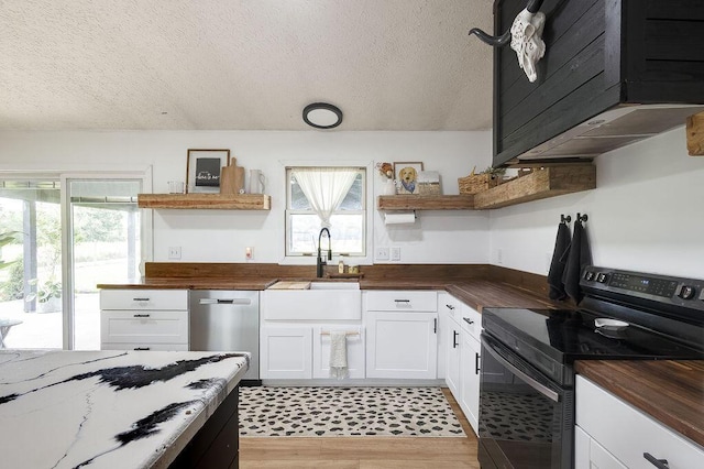 9710 Butcher Rd, Mount Vernon, OH 43050 - kitchen with black / electric stove, wooden counters, open shelves, dishwasher, and white cabinetry