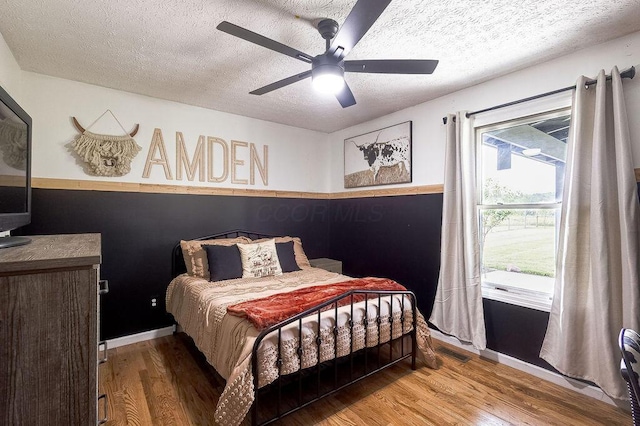 9710 Butcher Rd, Mount Vernon, OH 43050 - bedroom featuring wood finished floors, a textured ceiling, and ceiling fan