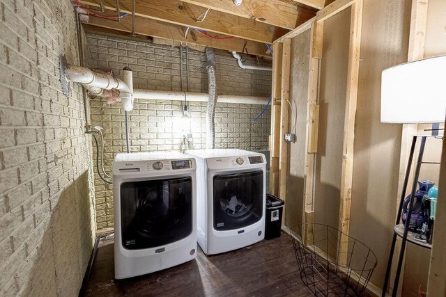 9710 Butcher Rd, Mount Vernon, OH 43050 - laundry area with independent washer and dryer, concrete block wall, and wood finished floors